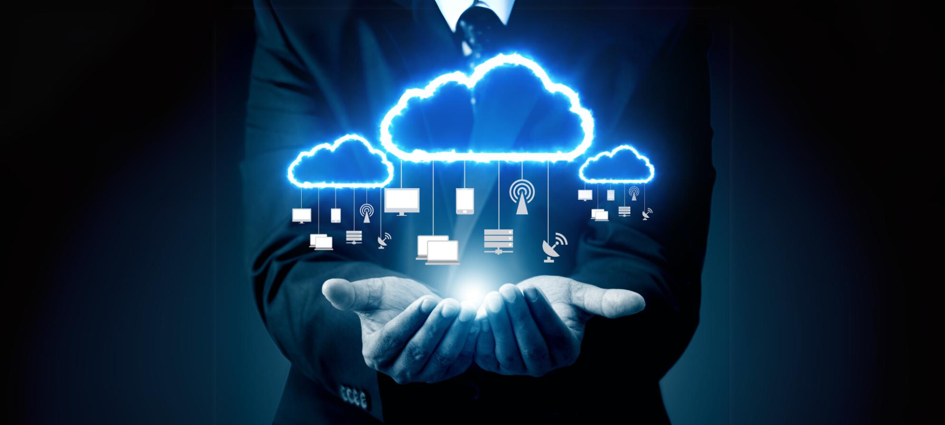 Business professional holding a glowing cloud icon with connected devices and technology symbols representing cloud infrastructure and IT support. Suitable for a cloud infrastructure page by 8086 IT Solutions, providing business IT support in Nottingham and the Midlands.